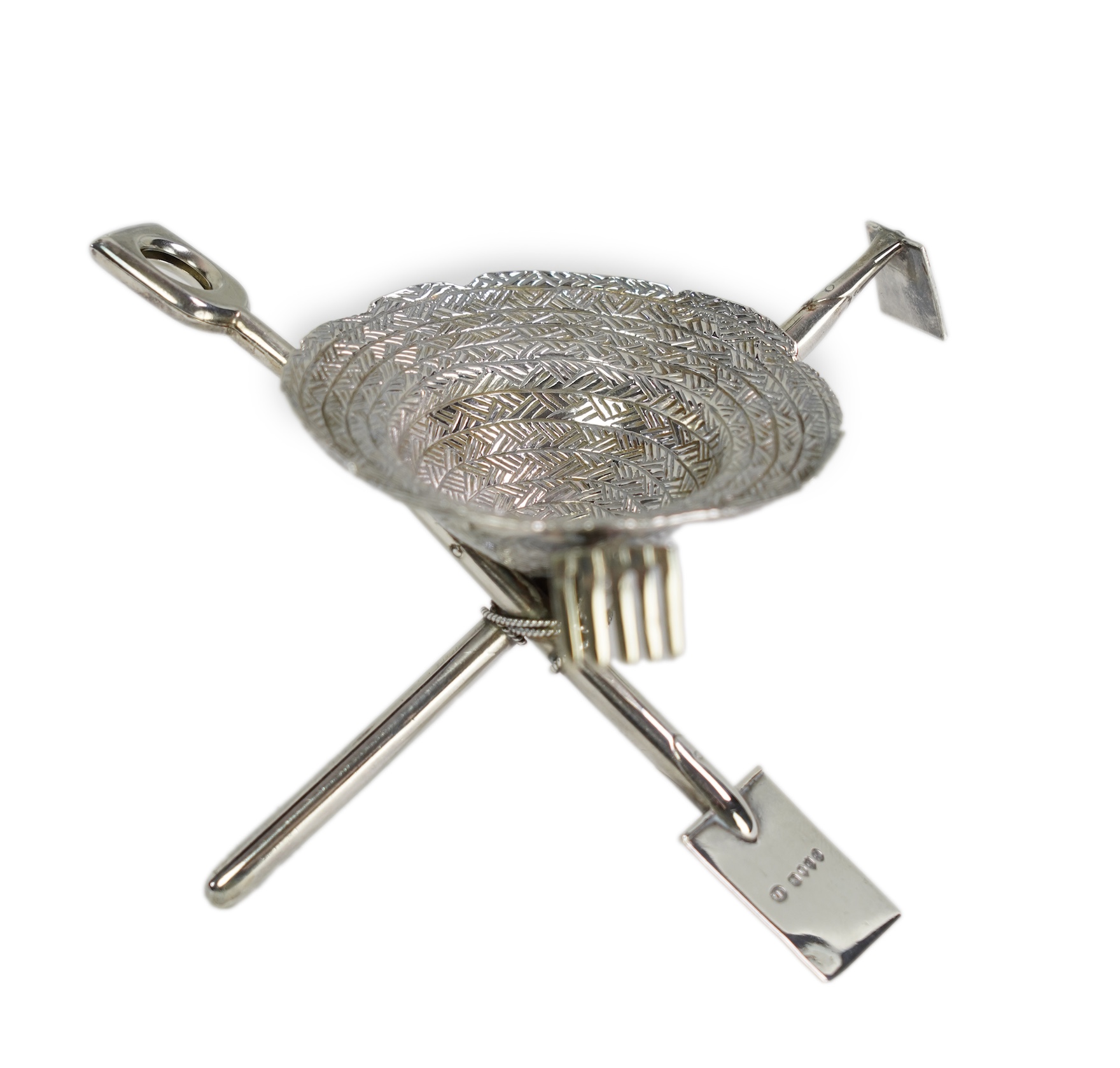 A rare Victorian novelty silver smoker's compendium set, modelled as an upturned straw hat with gardening tools tripod support, by Jane Brownett